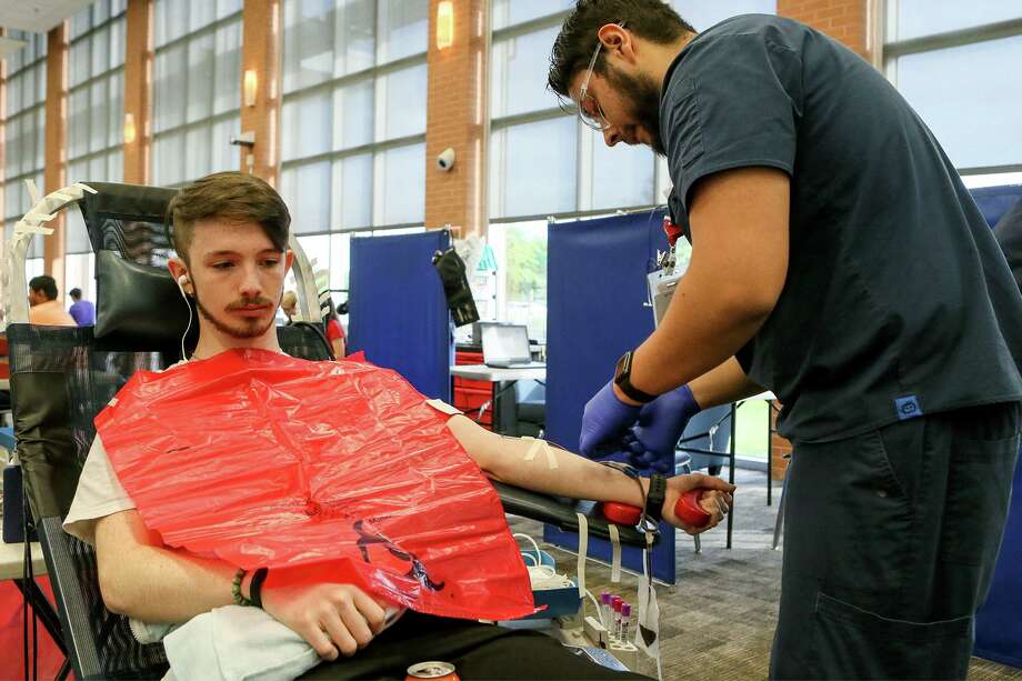 Sal Castaneda, right, with South Texas Blood and Tissue Center, prepares Jacob Scroggins, 17, for a blood donation during a blood drive on April 12, 2019. Photo: Marvin Pfeiffer /Staff File Photo / Express-News 2019