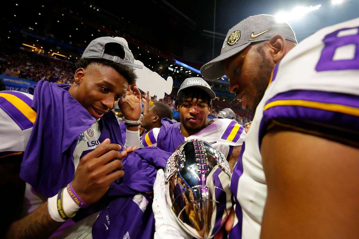 ATLANTA, GEORGIA - DECEMBER 28: Wide receiver Terrace Marshall Jr. #6 of the LSU Tigers and tight end Jamal Pettigrew #80 of the LSU Tigers celebrate their win over the Oklahoma Sooners during the Chick-fil-A Peach Bowl at Mercedes-Benz Stadium on December 28, 2019 in Atlanta, Georgia. (Photo by Todd Kirkland/Getty Images)