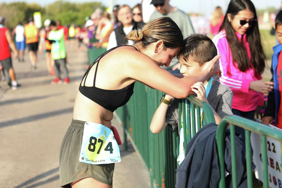 One of the more than 1,200 runners in last year’s inaugural Pearland Half Marathon greets a fan. The event will occur this year in March from Independence Park.