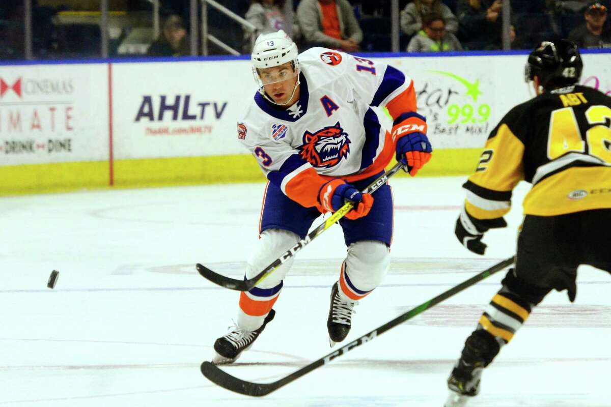 The Sound Tigers’ Colin McDonald (13) passes the puck during AHL hockey action against W-B/Scranton Penguins at the Webster Bank Arena in Bridgeport Oct. 19.