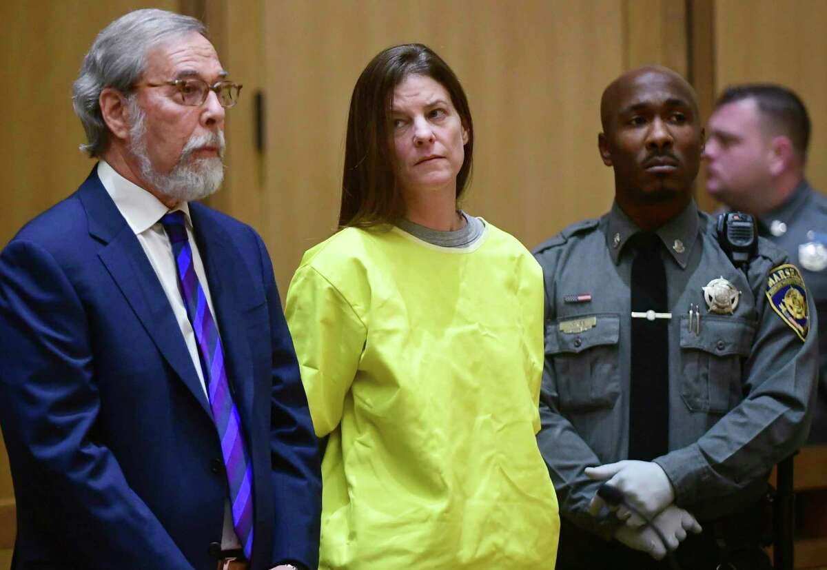 Michelle Troconis, center, is arraigned on conspiracy to commit murder charges in Stamford Superior Court Wednesday, January 8, 2020, in Stamford, Conn.