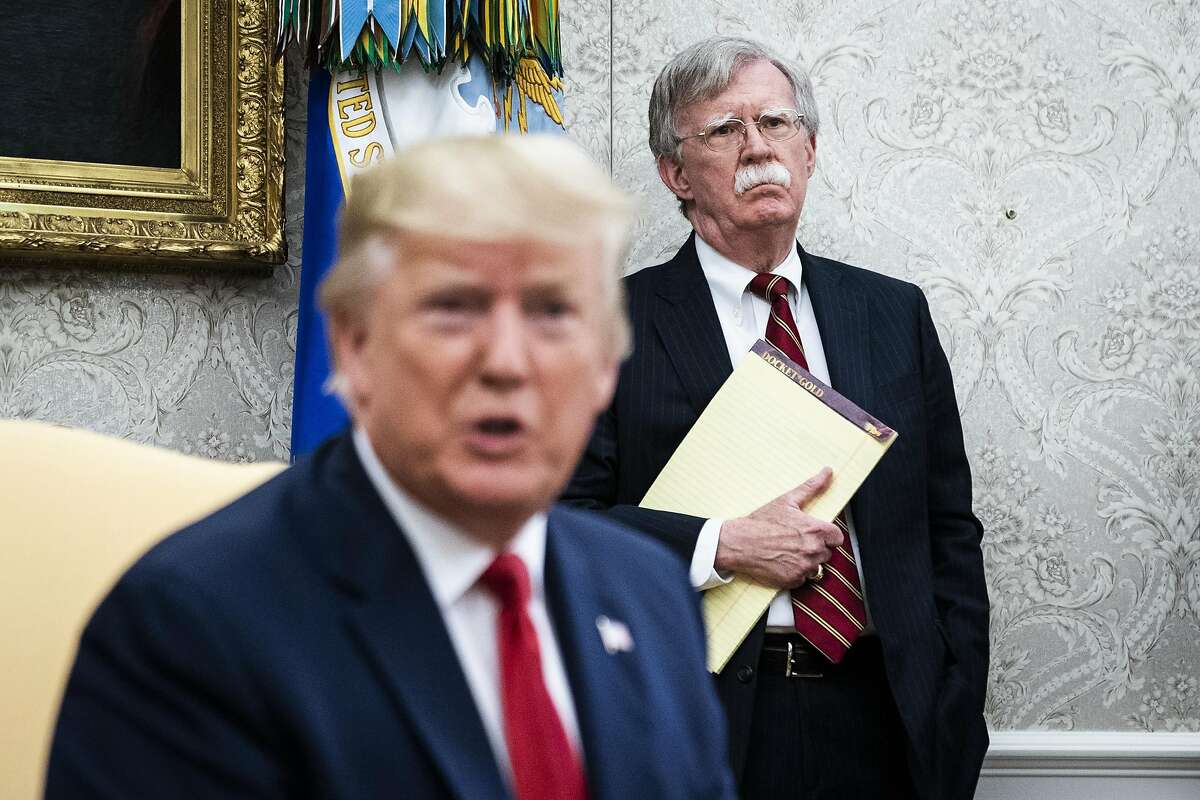 John Bolton listens to President Donald Trump in the White House in July 2019. MUST CREDIT: Washington Post photo by Jabin Botsford