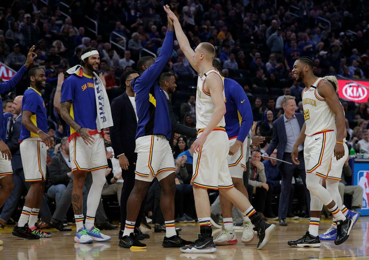 Warriors congratulate Alen Smailagic (6) after his three pointer in the first half as the Golden State Warriors played the Milwaukee Bucks at Chase Center in San Francisco, Calif., on Wednesday, January 8, 2020.
