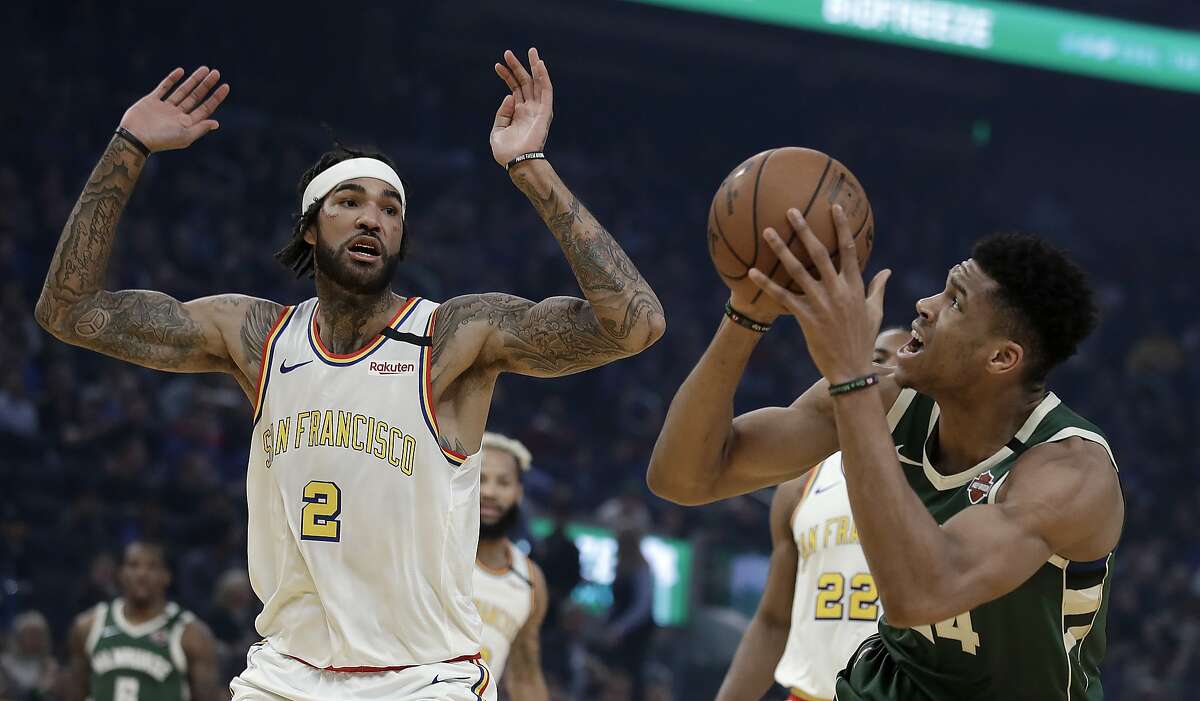 Milwaukee Bucks' Giannis Antetokounmpo, right, shoots as Golden State Warriors' Willie Cauley-Stein (2) defends during the first half of an NBA basketball game Wednesday, Jan. 8, 2020, in San Francisco. (AP Photo/Ben Margot)