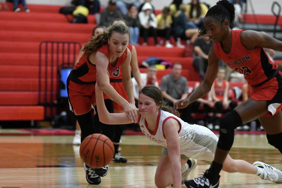 Huffman Hargrave junior Kyleigh Boyd-Smith, center, scrambles for a loose ball against a pair of Huntington defenders on a play late in the second quarter of a game at Hargrave High School on Jan. 7, 2020.