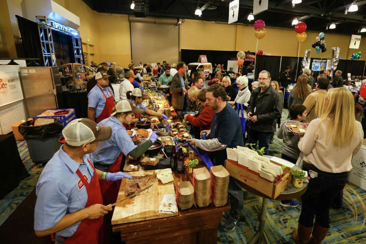Crowds surge by vendors during Taste of the Town on Thursday, Jan. 18, 2018, at The Woodlands Waterway Marriott Hotel & Convention Center.