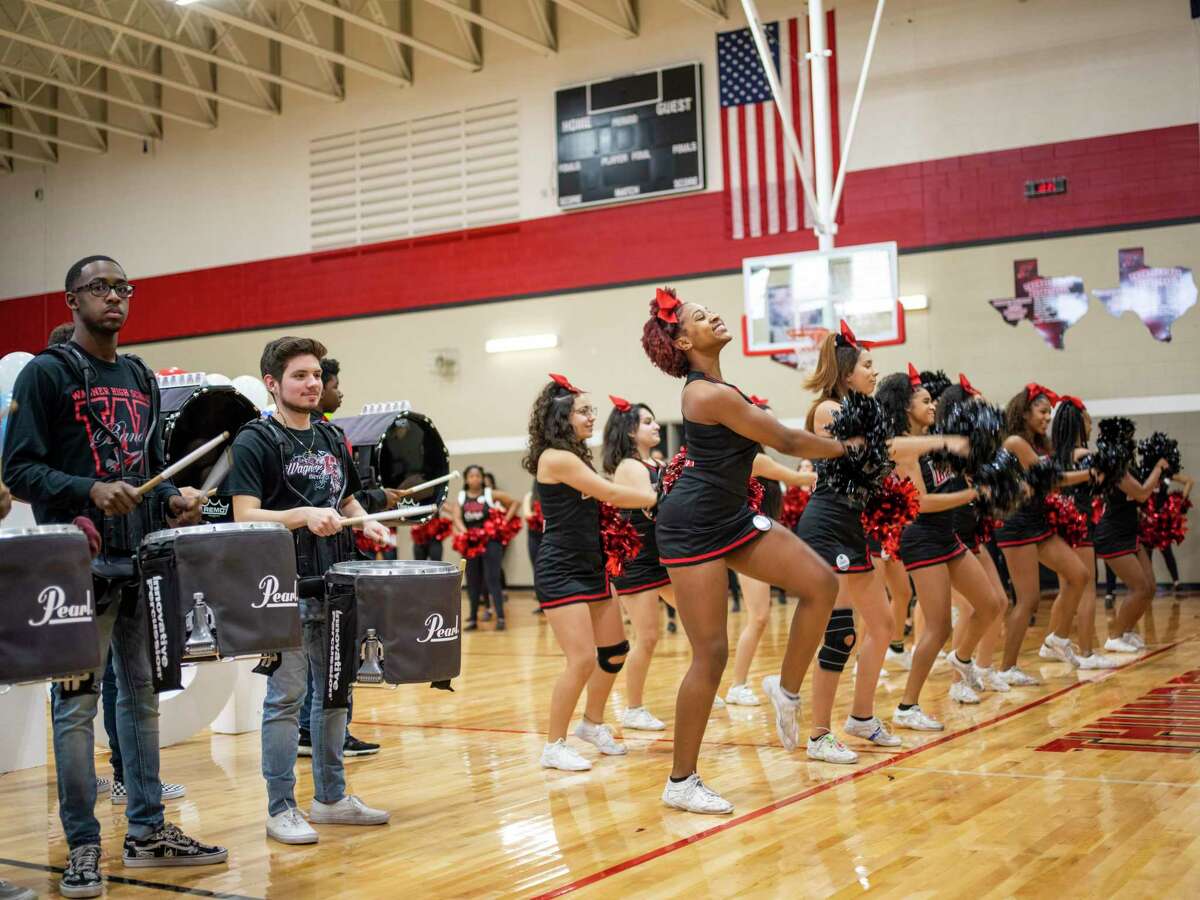 The drumline and cheerleaders of Karen Wagner High School perform during a pep rally Thursday celebrating that 100 percent of the more than 400 seniors have signed up for Alamo Promise, the free tuition program launched this year by the Alamo Colleges.