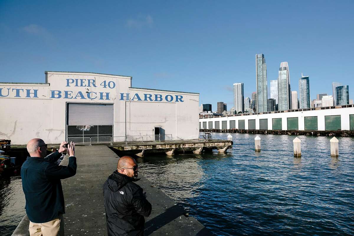 The Port of San Francisco's senior waterfront planner, David Beaupre, left, and communications director, Randy Quezada, take photos of the water facing sides of piers 40 and 38, in San Francisco, California, Thursday, January 9th, 2020. The Port of San Francisco is seeking new proposal ideas for Piers 38 and 40 that could include offices, retail, maritime and public uses.