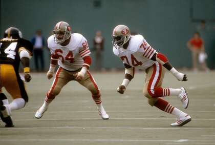 PITTSBURGH, PA - NOVEMBER 1: Defensive end Fred Dean #74 of the San Francisco 49ers pursues the play with linebacker Jack Reynolds #64 against the Pittsburgh Steelers during an NFL football game November 1, 1981 at Three Rivers Stadium in Pittsburgh, Pennsylvania. Dean played for the 49ers from 1981-1985. (Photo by Focus on Sport/Getty Images)