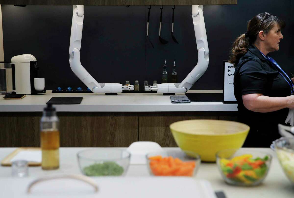 The Bot Chef is on display before a demonstration at the Samsung booth during the CES tech show, Tuesday, Jan. 7, 2020, in Las Vegas. The robot is designed to help with cooking tasks, not to make a meal all on it's own. (AP Photo/John Locher)