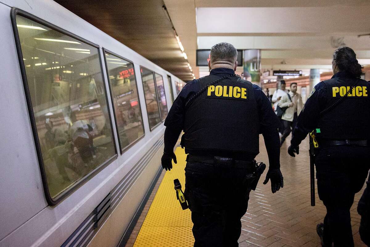 BART police officers patrol the platform level of Powell Street station in San Francisco, Jan. 9, 2020.