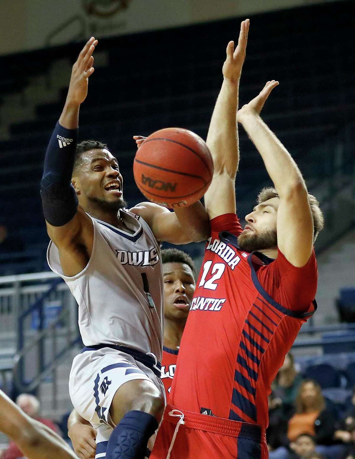 Rice Owls guard Josh Parrish (1) goes up for a basket against Florida Atlantic Owls forward Aleksandar Zecevic (12) during the first half of an NCAA men's college basketball game at Tudor Fieldhouse Thursday, Jan. 9, 2020, in Houston.