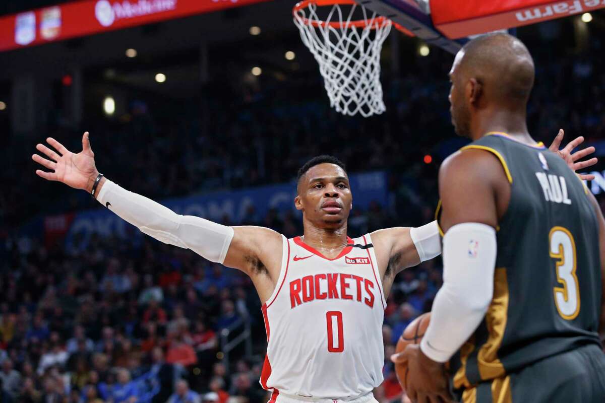 Houston Rockets guard Russell Westbrook (0) defends as Oklahoma City Thunder guard Chris Paul (3) looks to inbound the ball during the ball during the first half of an NBA basketball game Thursday, Jan. 9, 2020, in Oklahoma City. (AP Photo/Sue Ogrocki)
