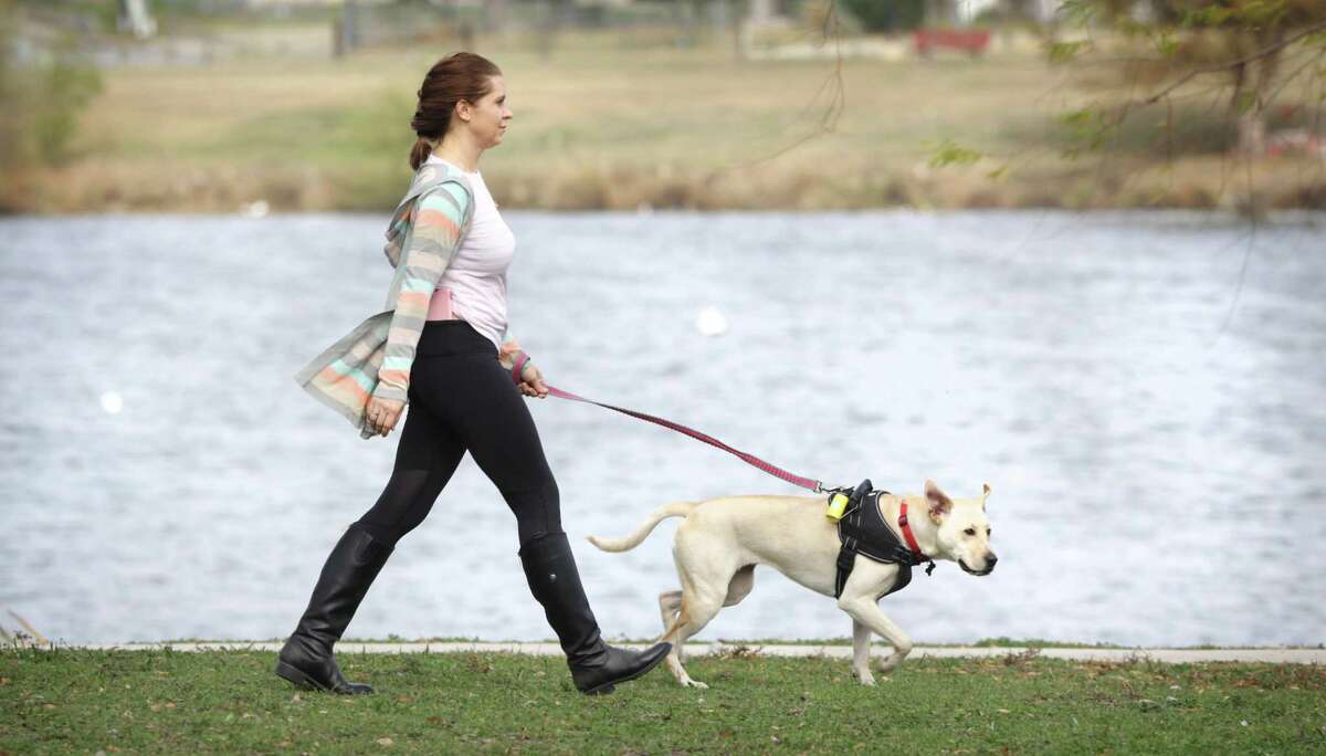 Alina Kaliuzhna, who was honorably discharged from the U.S. Army one year short of her contract, walks her dog Ivy, a 2 year-old rescue, at Woodlawn Lake.