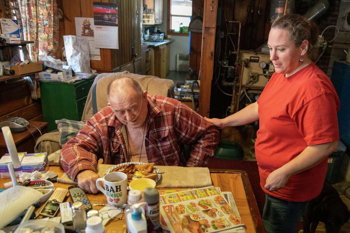 Home health aide Lisia Colegrove serves breakfast to client Thomas Wells. The nation's largest health care union is launching an extensive campaign in February 2022 to advocate for higher wages for workers. 