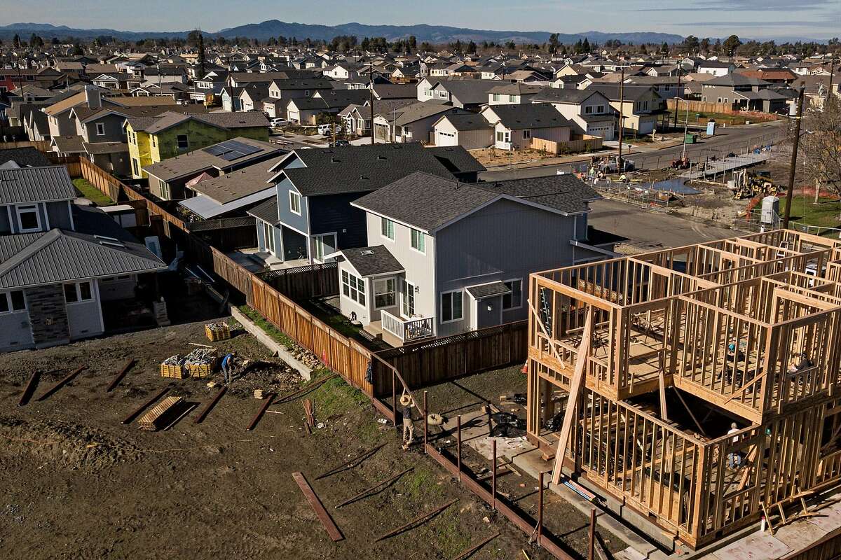 Workers build a home along Dogwood Drive in the Coffey Park neighborhood on Friday, Jan. 10, 2020, in Santa Rosa, Calif.