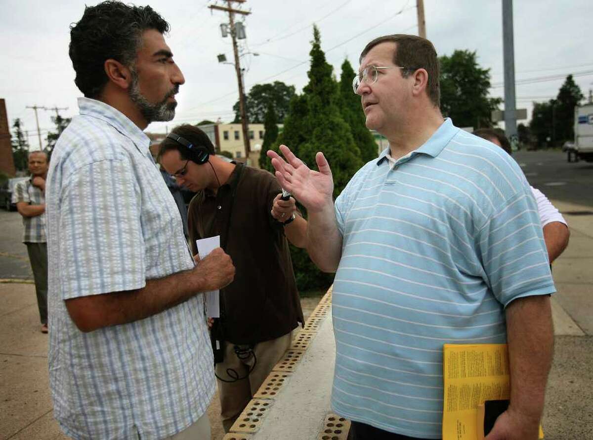 Mongi Dhaouadi, left, executive director of the Council on American Islamic Relations, talks with Christian protestor John Payne of Milford outside Masjid An-Noor mosque on Fairfield Avenue in Bridgeport on Thursday, August 12, 2010. Tensions have been high since Chrsitian protestors began handing out anti-Islamic literature outside the mosque.