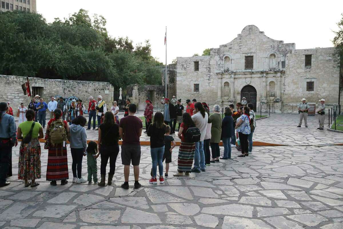 A local Native American group honored buried descendants during their 25th Annual Sunrise Ceremony at the Alamo on Saturday, Sept. 7, 2019. Ramon Juan Vasquez, executive director of American Indians in Texas at the Spanish Colonial Missions, along with over 60 people who claim ancestry with the Native Indians who are buried on the grounds of the Alamo, formed a circle in front of the church to pray and honor their descendants. In the past, the group was allowed to have the service inside the chapel but were told days before the event that the service would not be permitted inside the Alamo. With a noticeable presence of Alamo security officers and chain blocking the walking to the front doors, the group formed a circle on Alamo Plaza to air their grievances and to remember their descendants. Vasquez and the group was joined by State Senator Jose Mendendez, State Rep. Leo Pacheco and Poet Laureate Carmen Tafolla who all expressed dismay that the indigenous group would not be allowed to pray and honor their loved ones inside the Alamo. Despite the prohibition, members of the Tap Pilam Coahuiltecan Nation and other indigenous people paid their respects on the ground by the front of the Alamo. A shell filled with sage slowly burned and filled the early morning sky with wafts of smoke - which traditionally serves to bless and purify - as the service ended just as the sun rose over the Alamo. (Kin Man Hui/San Antonio Express-News)