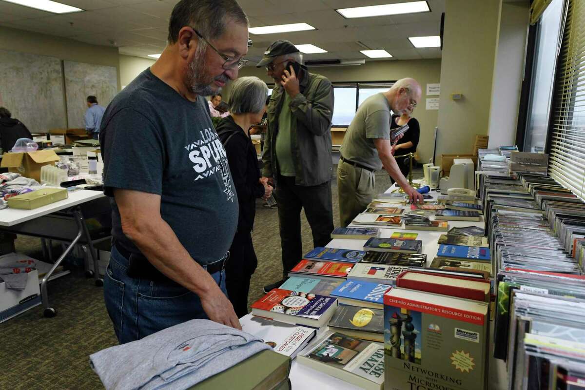 Jose Castillo, a long-time listener of public radio, looks through books during a “garage sale” at Texas Public Radio headquarters on Friday, Jan. 10, 2020. Texas Public Radio is preparing its move from its high-rise offices near the Medical Center to the Alameda Theater complex in downtown San Antonio next month.