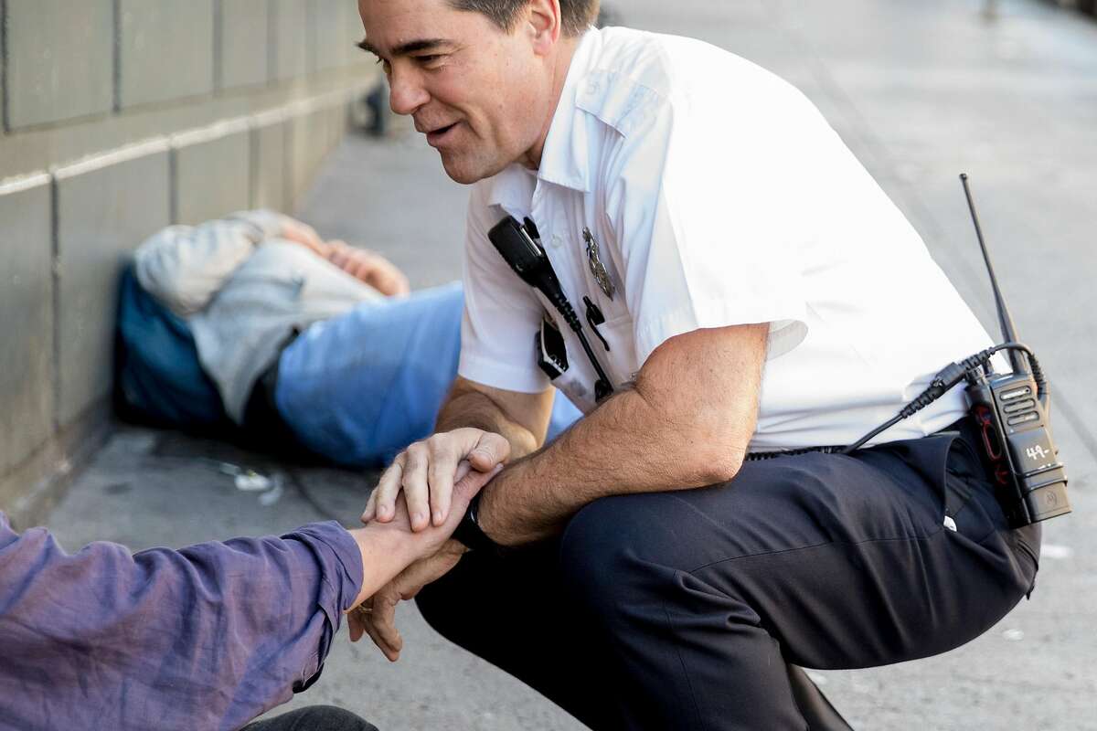 EMS-6 Captain Scott Eberhart greets a familiar face while walking the Tenderloin to identify at-risk homeless people during a high-intensity care team shift managing and facilitating high-impact patient cases of those suffering from addiction and mental illness on the streets in San Francisco, Calif. Friday, Jan. 10, 2020.