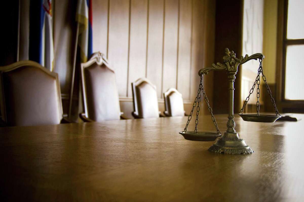File photo of the Scales of Justice in an an empty courtroom.