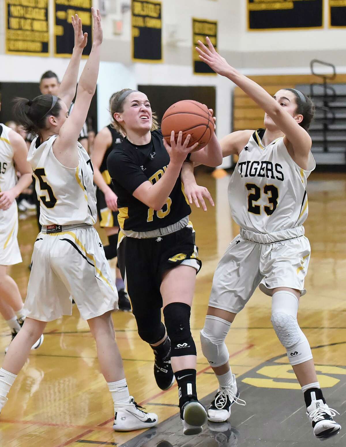 Amity’s Jillian Martin drives to the basket against Hand on Friday.