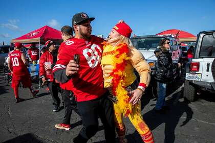 Gurchet Sanghera (left) and Nicole Manasewitsch gear up for the game during a tailgate party outside Levi’s Stadium.