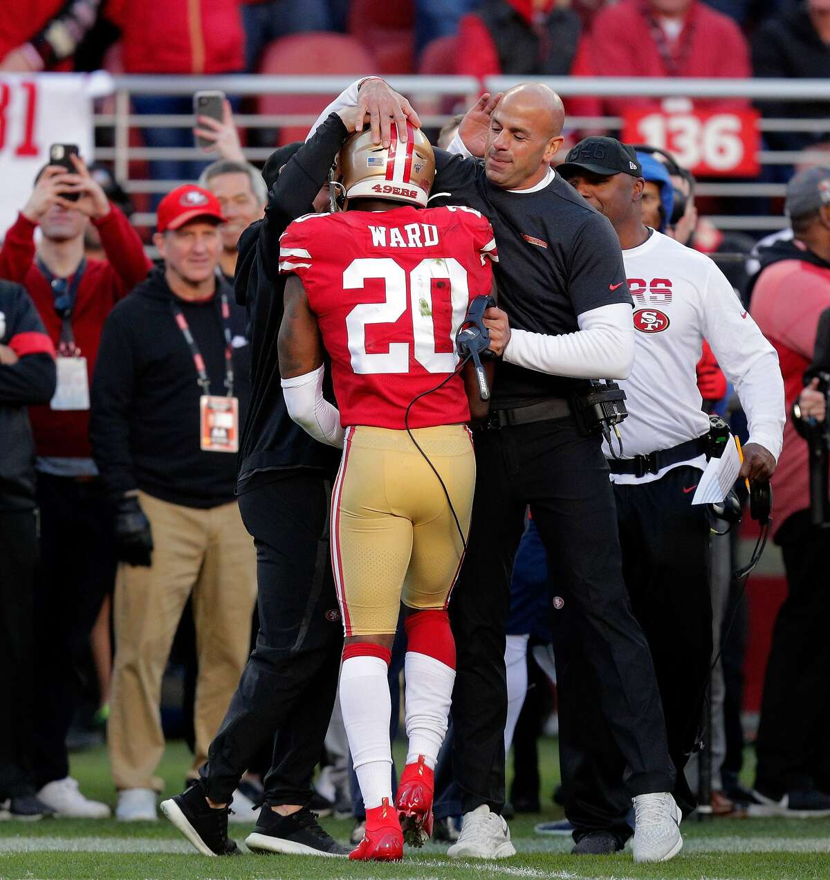Defensive coordinator Robert Saleh hugs Jimmie Ward (20) after he broke up a pass late in the fourth quarter as the San Francisco 49ers played the Minnesota Vikings in the NFC Divisional Round playoff game at Levi’s Stadium in Santa Clara, Calif., on Saturday, January 11, 2020. The 49ers defeated the Vikings to advance to the NFC Championship game.