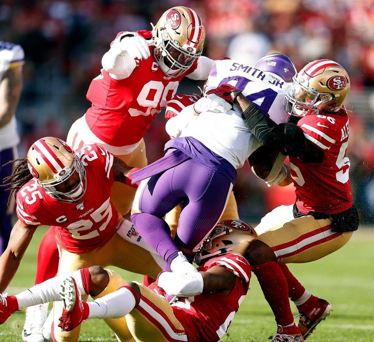 San Francisco 49ers' Kwon Alexander, DeForest Buckner, Richard Sherman and Jimmie Ward team up to stop Minnesota Vikings' Irv Smith, Jr. in 1st quarter of Niners' 27-10 win during NFC Divisional playoff game at Levi's Stadium in Santa Clara, Calif., on Saturday, January 11, 2020.