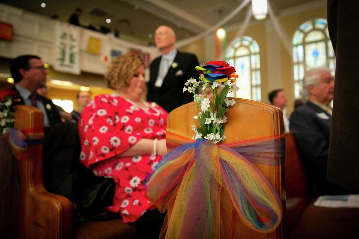 Rainbow flowers and tulle decorate the pews during a Blessing of Unions service at Bering Church.