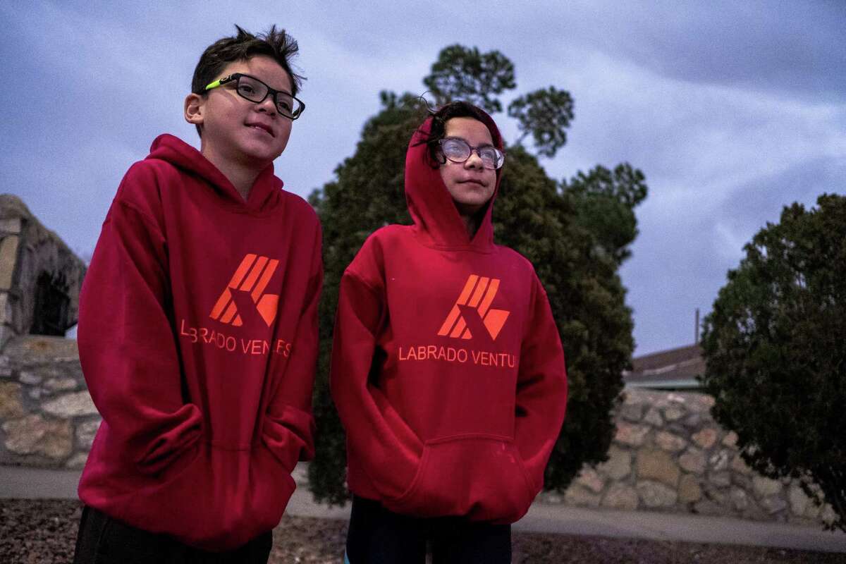 Damian Labrado, 12, left, and his sister Nahomy, 12, pose for a portrait after finishing a morning run in El Paso. The Labrado siblings are training to run in the Chevron Houston Marathon later this month.