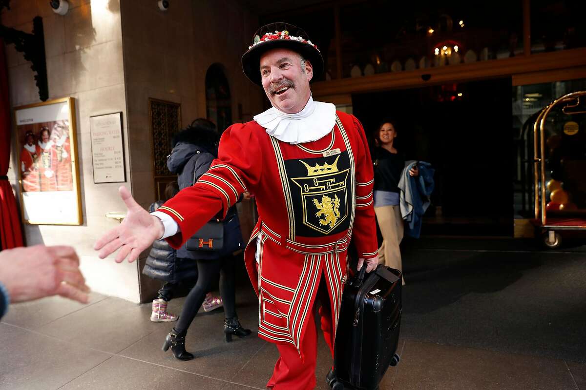 Beefeater doorman Tom Sweeney greets a hotel guest during the final day of his 43 year long career at the Sir Francis Drake Hotel in San Francisco, Calif., on Sunday, January 12, 2020.