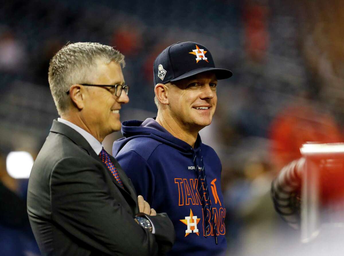 Astros general manager Jeff Luhnow and manager A.J. Hinch, chatting during the 2019 World Series, were both fired by owner Jim Crane after MLB’s report on the team’s sign stealing was released.