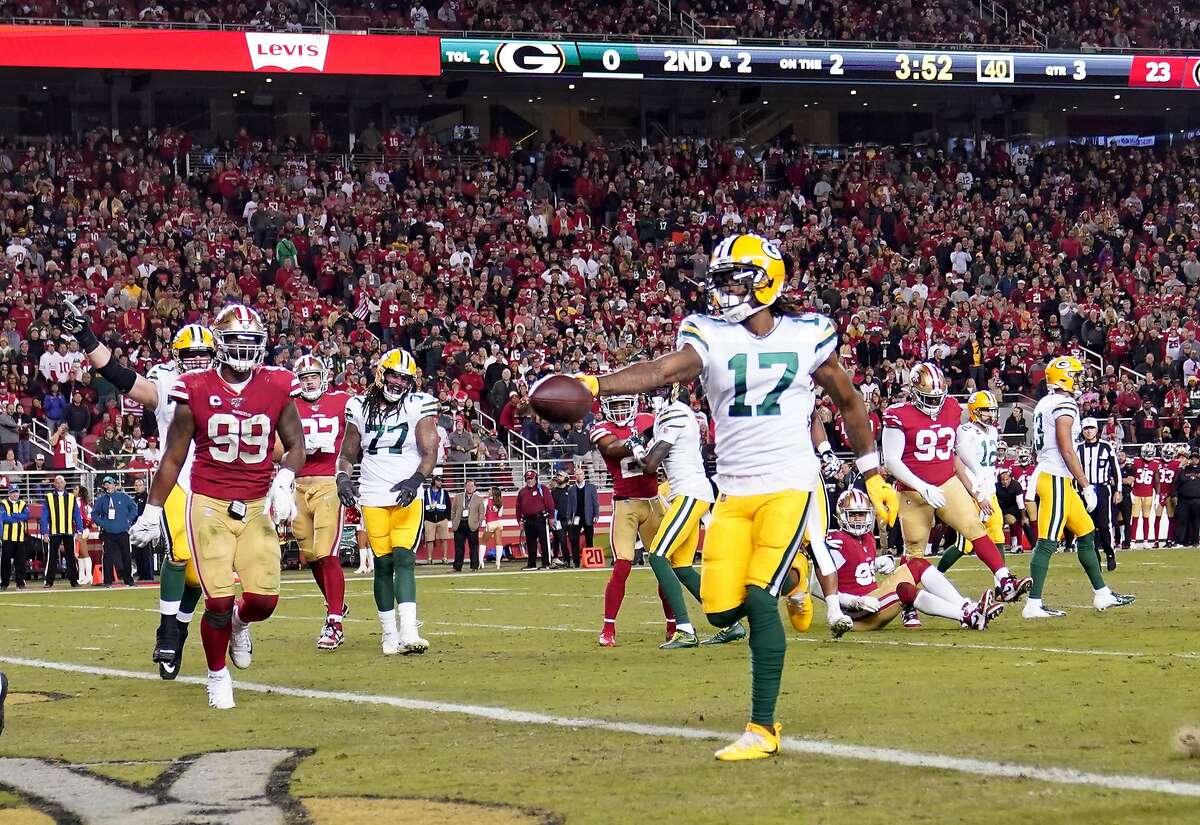 Santa Clara, CA, USA. 26th Sep, 2021. Green Bay Packers' AJ Dillon (28) is  tackled by San Francisco 49ers' Azeez Al-Shaair (51) and San Francisco 49ers'  Emmanuel Moseley (4) after a pass