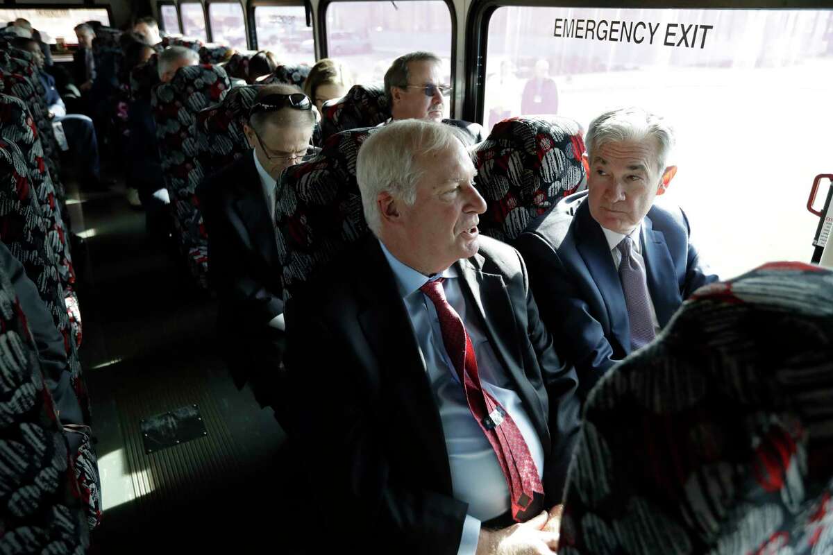 Federal Reserve Bank of Boston President Eric Rosengren, center front, and Federal Reserve Board Chairman Jerome Powell, right, participate in a bus tour of East Hartford on Nov. 25. They toured a neighborhood and met with residents as part of the Boston Fed’s Small Cities Challenge. On Monday, Rosengren, in Hartford, said the economy is entering a ‘soft landing.’