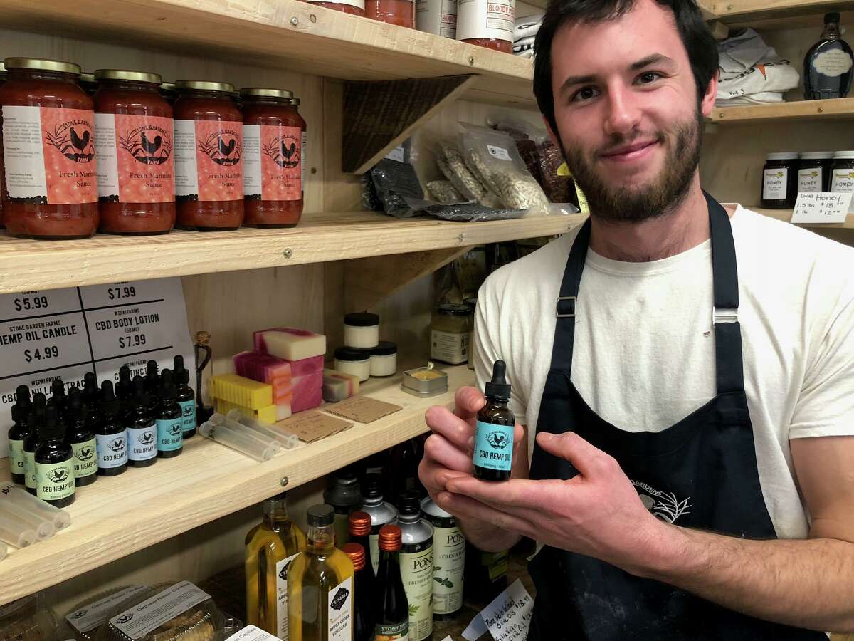 Tommy Monahan displays some of the CBD and hemp products available at the Stone Gardens Farm store.