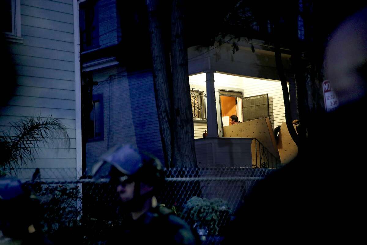 Folks board up "Mom's House", the Magnolia Street house that had been occupied by the Moms 4 Housing group, following the arrests of members Misty Cross and Tolani King by the Alameda Sheriff's Office in Oakland, Calif., on Tuesday, January 14, 2020. A third person, Jesse Turner, was also arrested. A judge on Friday ruled that Moms 4 Housing did't have a legal right to the property and that they would be evicted by the Sheriff's Office within days.