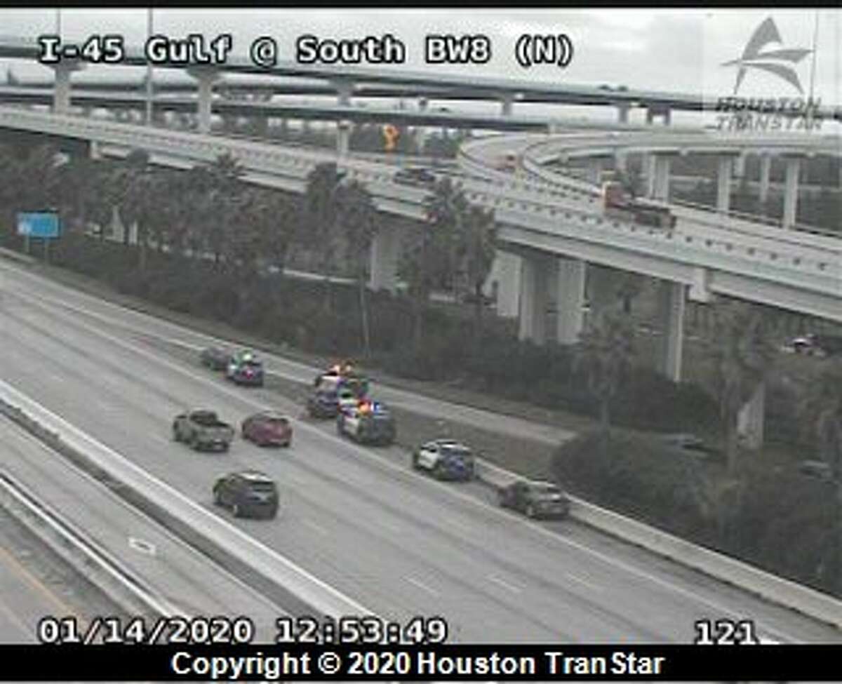 Houston police are seen on the Gulf Freeway near Beltway 8 after police say a man who was being detained for walking along the freeway suddenly stopped breathing and later died Tuesday, Jan. 14, 2020.