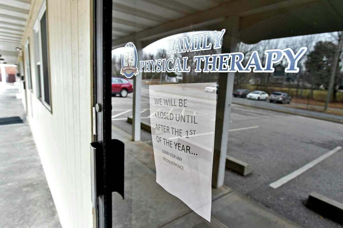 Colchester, Connecticut - Tuesday, January 14, 2020: A sign in a door of Family Physical Therapy in the small complex of 7 Park Ave. in Colchester owned by Anthony Todt, who may be connected to the 4 people found dead in Celebration, Florida, according to officials. The sign reads "We will closed until after the 1st of the year…Sorry for any inconvenience." Officials in the southeastern town of Colchester are asking residents to come together after a missing local family was linked to the discovery of the bodies in Celebration, Florida. Anthony Todt, 44, and his wife Megan, 42, have not been in contact with family since Jan. 6, according to several news reports.