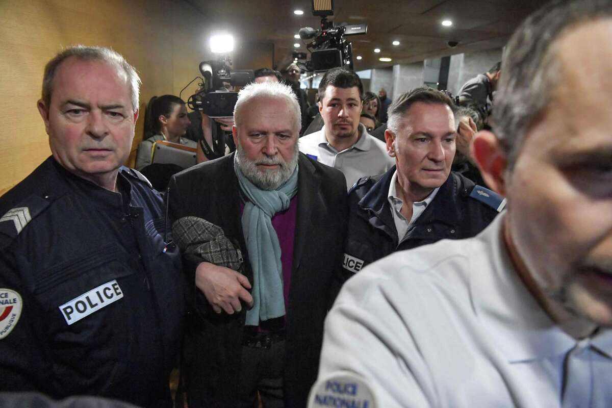 Bernard Preynat, a French former priest accused of sexual assaults, leaves a Lyon courthouse.
