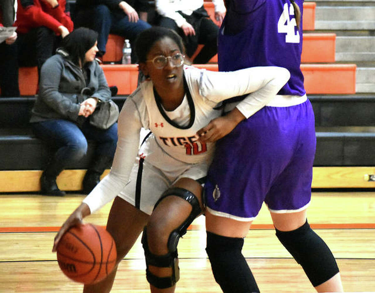 Edwardsville forward Amanda Mills tries to drive baseline before being cut off by a Collinsville defender in the fourth quarter Tuesday inside Lucco-Jackson Gymnasium.