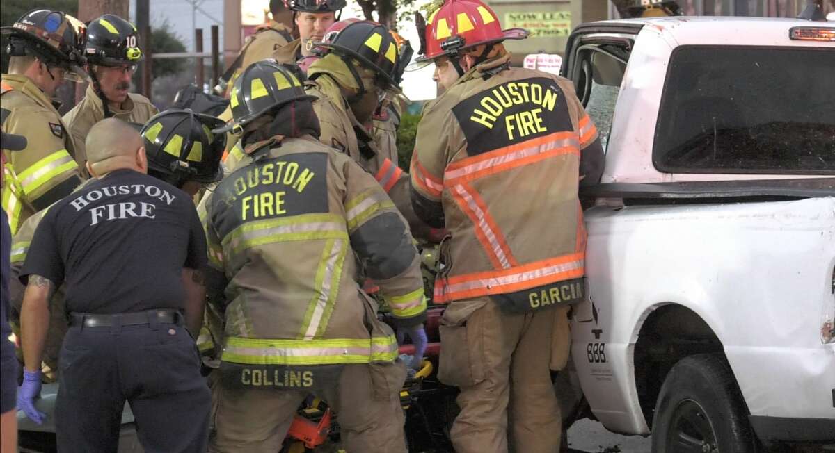 Houston firefighters work the scene where a driver who crashed into a utilty pole was trapped and freed from the car by rescuers Wednesday, Jan. 15, 2020.