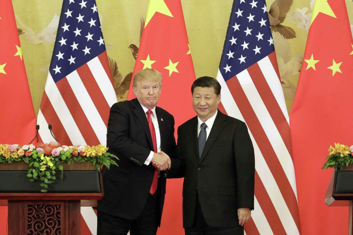 File photo of President Donald Trump, left, and Xi Jinping, China's president, shaking hands during a news conference at the Great Hall of the People in Beijing on Nov. 9, 2017.