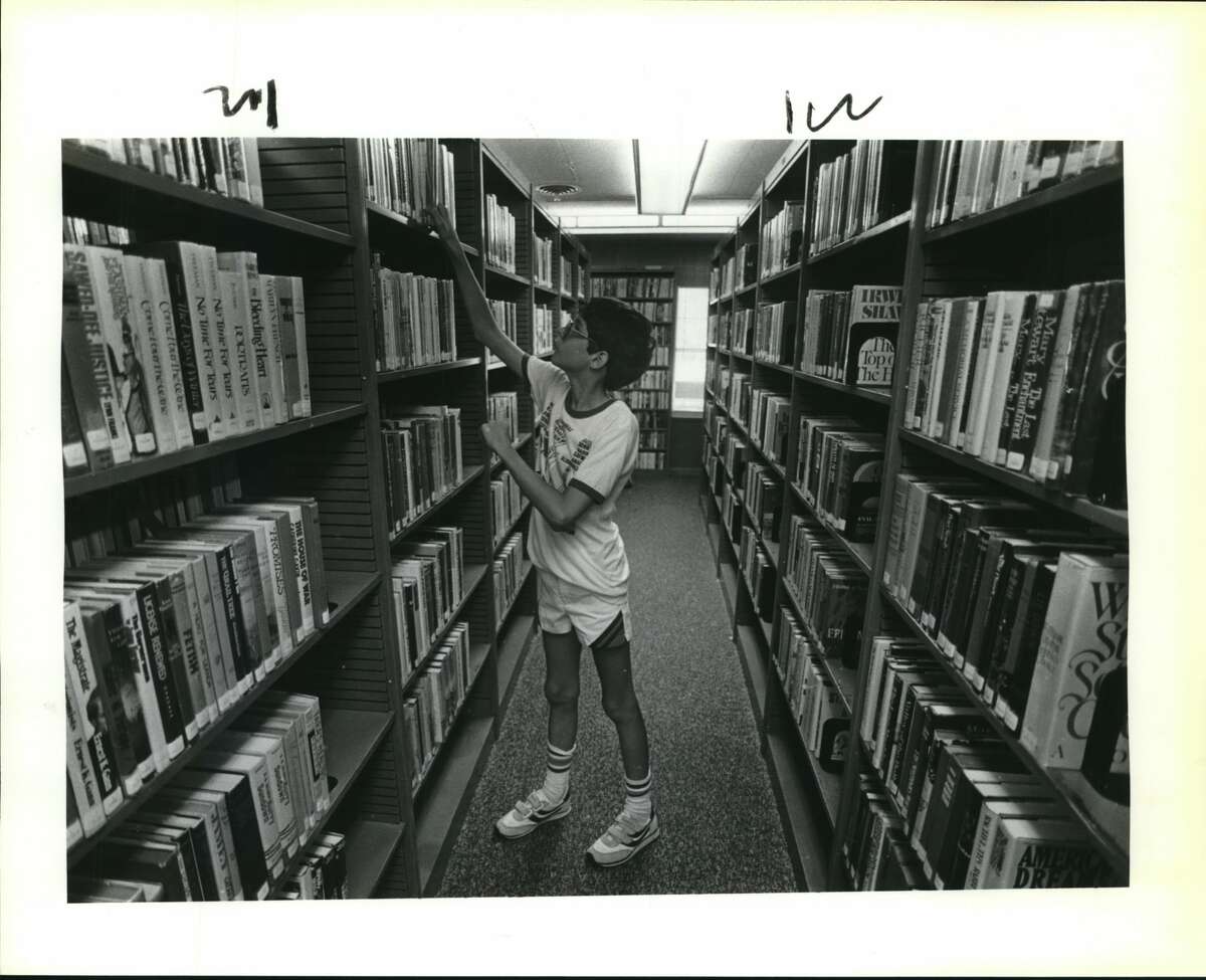 University City's 1st library. University City Library. Billy Tabb goes through books.