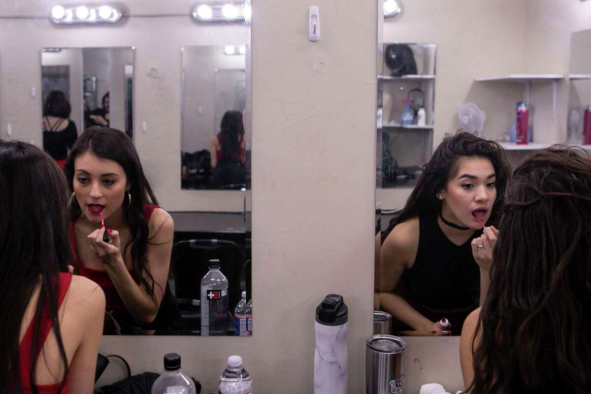 Lauren Cosio, left, and Jillian Sainz, right, apply lipstick before taking the stage in the final round of auditions for the Woodlawn Theatre's staging of "On Your Feet!" The Woodlawn is the first theater group in Texas to produce the Gloria Estefan jukebox musical.