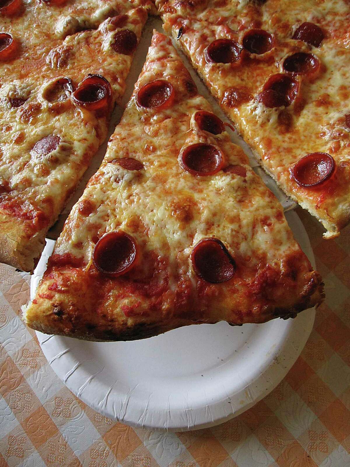 Pizza options include classic pepperoni at Capo's Pizzeria on Broadway.