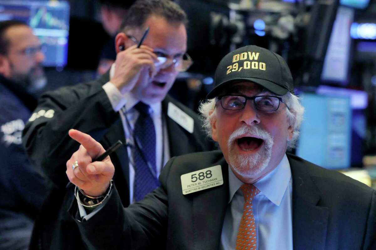 Trader Peter Tuchman wears his "Dow 29,000" hat as he works on the floor of the New York Stock Exchange, Wednesday, Jan. 15, 2020, as the Dow Jones industrial average closed above 29,000 for the first time. (AP Photo/Richard Drew)