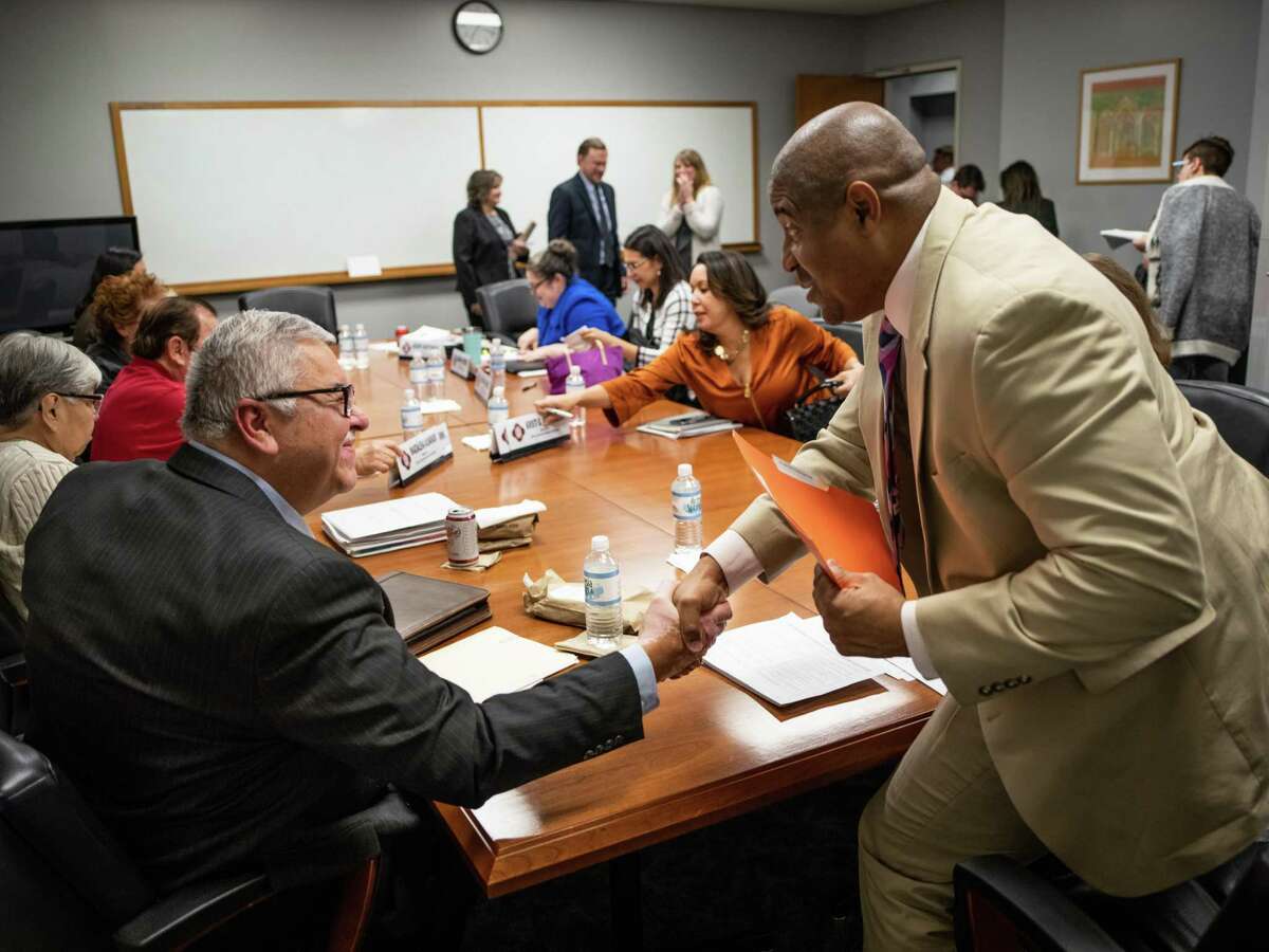 A meeting of the San Antonio Ethics Review Board ends with a handshake between board member Ruben De Leon, left, and the board’s chair, Patrick Lang, right, on December 3, 2019. The City Council’s Governance Committee on Wednesday voted unanimously to send a proposed set of changes to the city’s Ethics Code to the board for its consideration.
