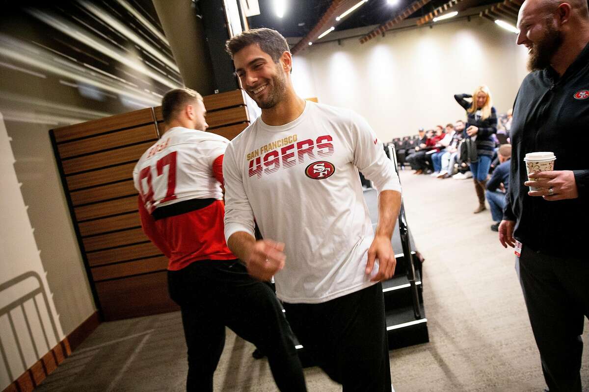 San Francisco 49ers quarterback Jimmy Garoppolo (10) exits as 49ers defensive end Nick Bosa (97) makes his way to a news conference at Levi’s Stadium, Wednesday, Jan. 15, 2020, in Santa Clara, Calif. The 49ers will play the Green Bay Packers in the NFC Championship game on Sunday.