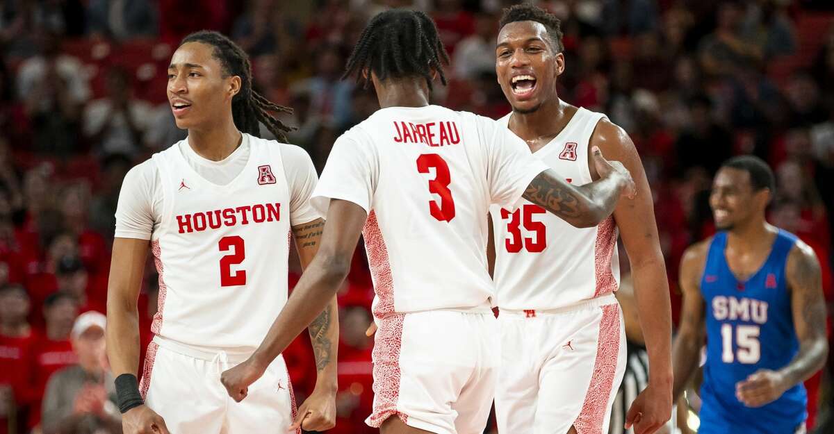 Houston Cougars guard Caleb Mills (2), guard DeJon Jarreau (3) and forward Fabian White Jr. (35) celebrate after a play during the second half of the Cougars' game against the Mustangs at the Fertitta Center in Houston, Wednesday, Jan. 15, 2020.
